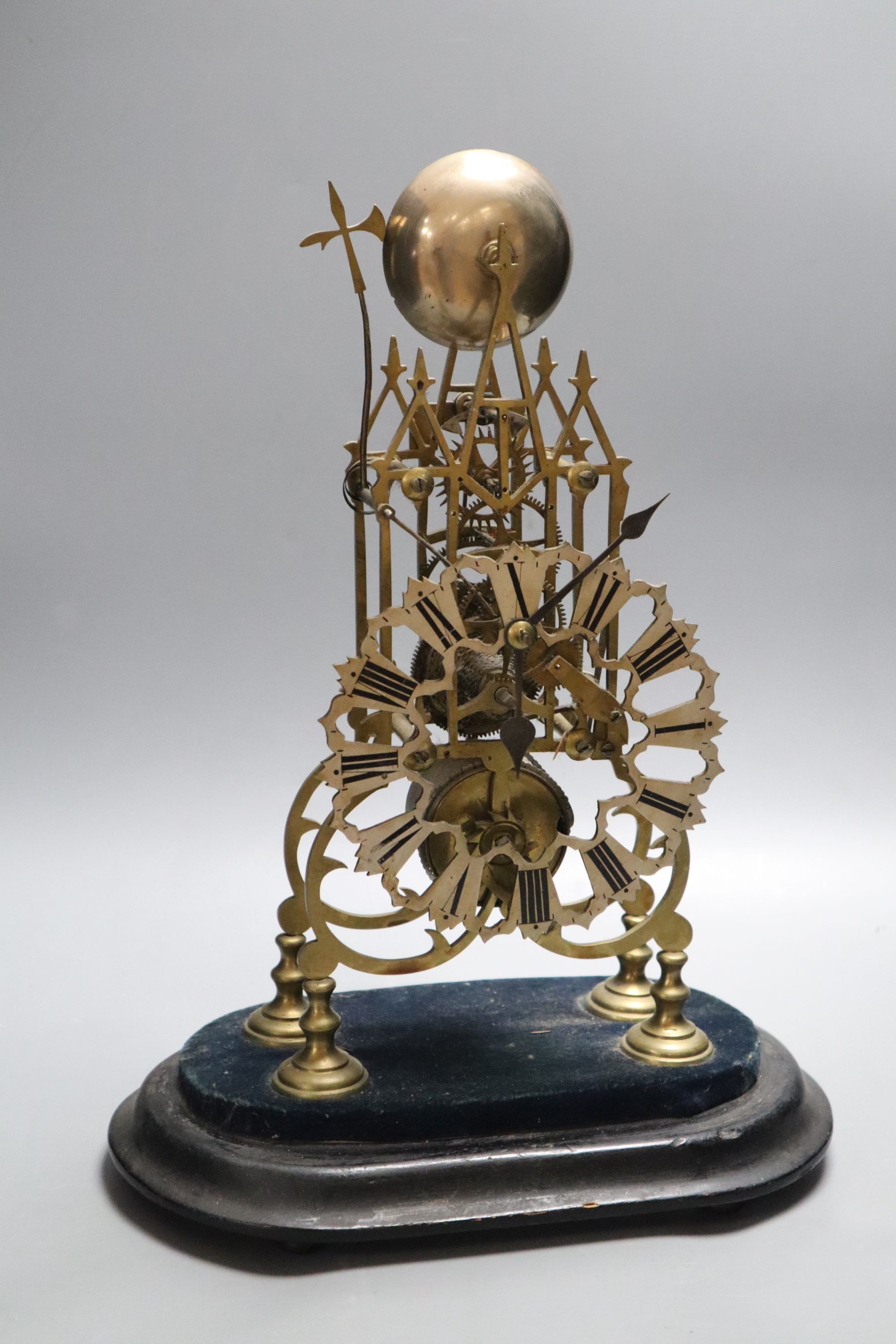 A Victorian brass skeleton clock, under dome